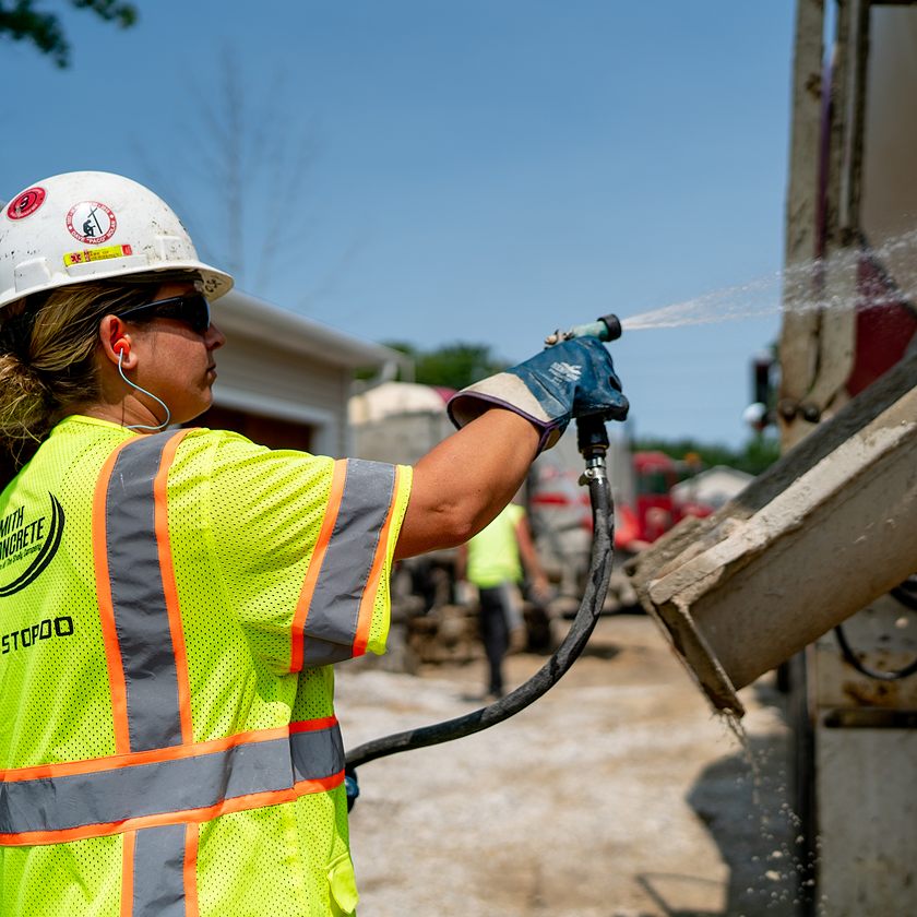 crh employee spraying concrete truck