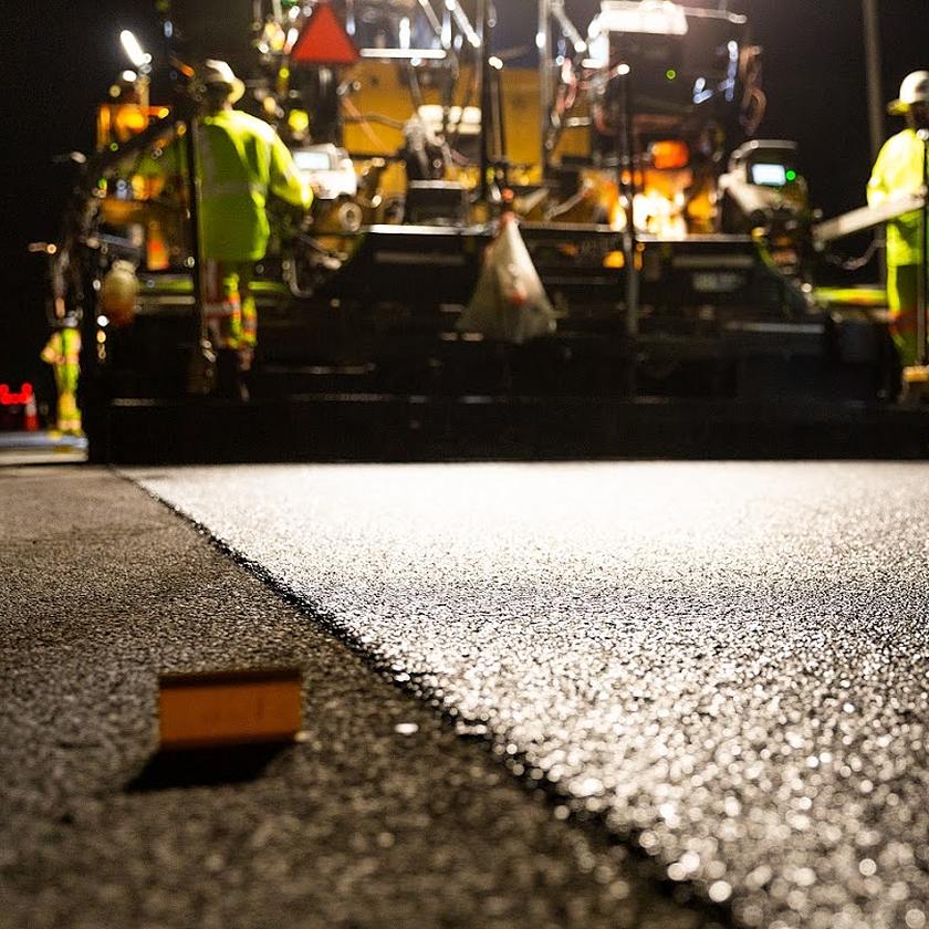 road paver at night